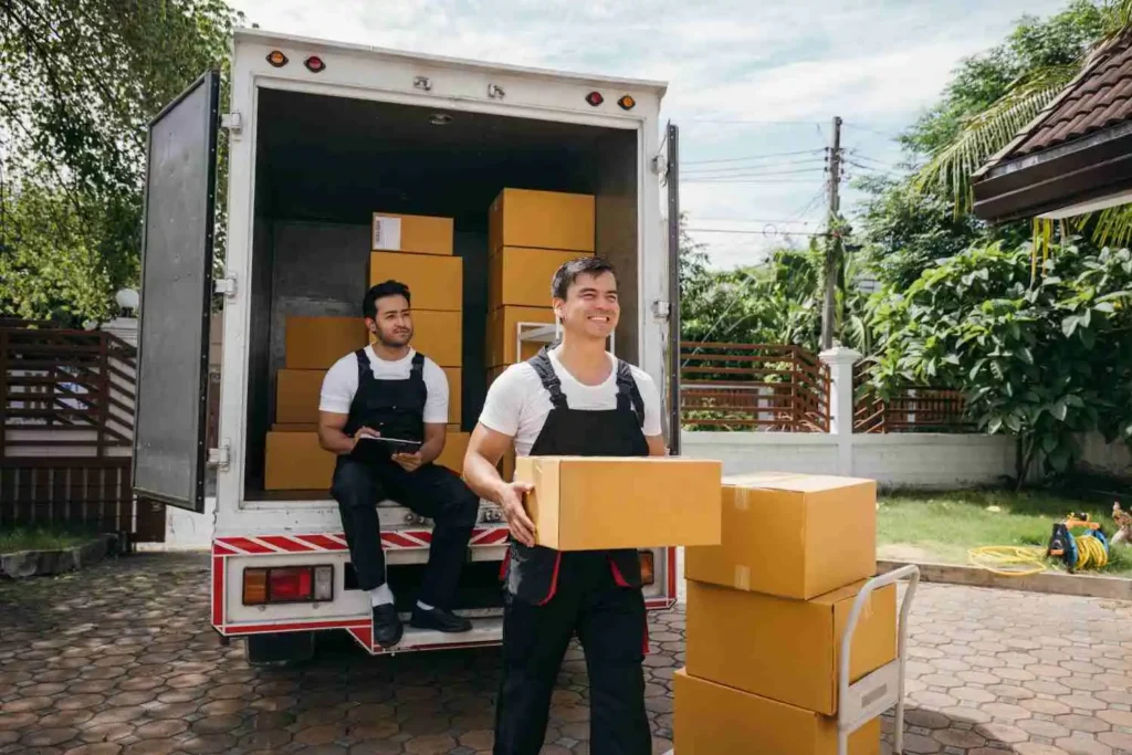 Long distance movers in Florida loading a dedicated carrier truck in Fort Lauderdale