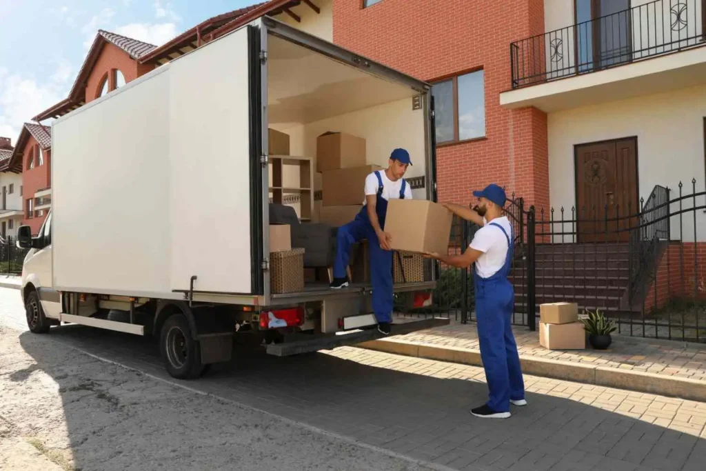 Moving Hub vs American Van Lines comparison, moving crew loading a dedicated truck outside a South Florida home