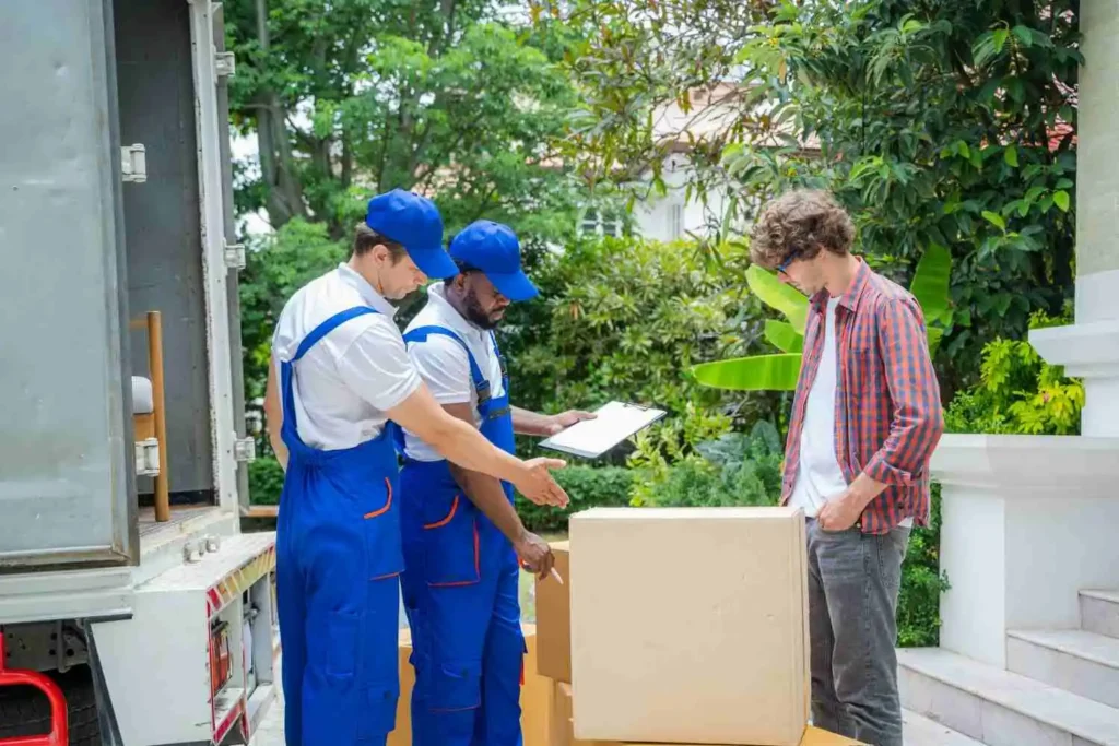 Moving Hub vs Mayflower comparison showing a moving crew loading a dedicated truck outside a South Florida home