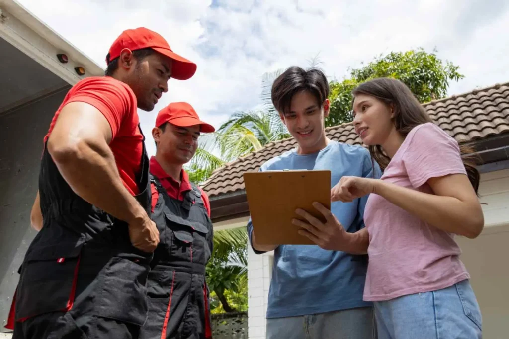 Moving Hub vs United Van Lines comparison showing a crew lead reviewing an inventory with a homeowner before loading