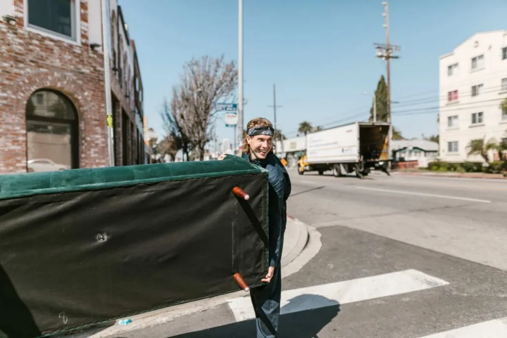 Moving Hub vs Two Men and a Truck comparison, crew loading a dedicated moving truck outside a Florida home