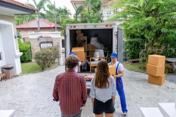 Movers loading a truck outside a home for a long-distance move